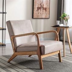 a chair sitting on top of a rug in a living room next to a table