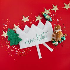 a piece of paper that says nice list with gingerbreads and christmas decorations around it