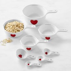 measuring spoons and measuring cups with oats in them