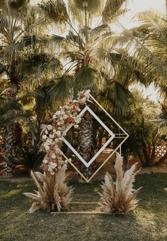 the wedding arch was decorated with pamodia, pamolite and palm trees