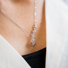 a close up of a woman wearing a necklace Triple Heart, Crystal Heart Necklace, Crystal Heart Pendant, Herringbone Necklace, Heart Pendants, Coin Pendant Necklace, Cz Necklace, Freshwater Pearl Necklaces, Coin Pendant