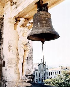 a bell hanging from the side of a building