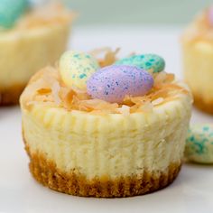 several small desserts on a white plate with sprinkles and eggs in them