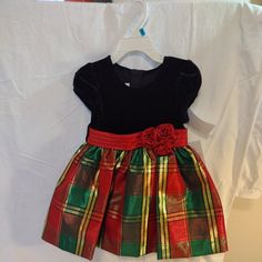 Bonnie Baby Girls Christmas Holiday Dress New With Tags Toddler Baby Dress Red, Green, And Gold Plaid Skirt With Red Decorative Bow And Black Bodice. 24 Months. Bonnie Jean's Signature Christmas Dress. Classic Red, Gold, And Green Plaid With A Stretch Black Velvet Bodice And Ribbon Flower At Waist. Has Attached Red Petticoat And Matching Red Panties Or Diaper Covers.Style: Hope Matching Sister Dress: Available In All Size Ranges Polyester, Spandex, Metallic Machine Wash Cold, Gentle Cycle Origin Red Christmas Playtime Dress, Festive Short Sleeve Holiday Dress For Christmas, Festive Holiday Dress With Short Sleeves, Festive Short Sleeve Holiday Dress, Christmas Dress For Baby, Red Baby Dress, Christmas Dress Baby, Matching Sisters, Dress For Baby