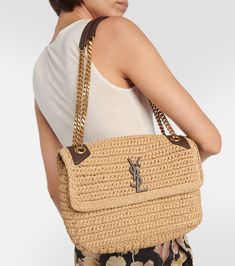 Niki Medium Raffia Shoulder Bag in Beige - Saint Laurent | Mytheresa Designer Crochet Tote Bag For Travel, Designer Beige Crochet Tote Bag, Designer Woven Straw Bag For Travel, Designer Beige Crochet Bag For Travel, Luxury Crochet Tote Bag For Travel, Designer Summer Shoulder Bag With Braided Handles, Designer Summer Straw Shoulder Bag, Designer Woven Straw Travel Bag, Luxury Straw Tote Shoulder Bag