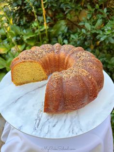 a bundt cake sitting on top of a white plate with a slice cut out