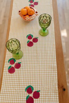 a table runner with apples and oranges on it