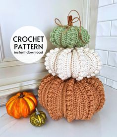 crochet pumpkins are stacked on top of each other