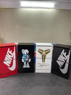 four boxes with different logos on them sitting in a room