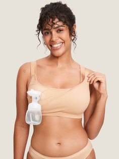 a woman wearing a tan bra with an inflatable bottle attached to her breast