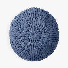 a blue round pillow on a white background