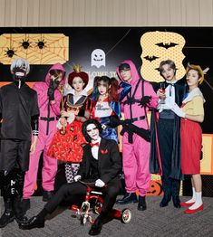 a group of people in costumes posing for a photo