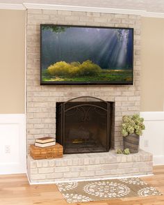 a flat screen tv mounted above a fireplace