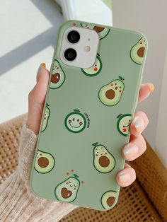 a woman holding an iphone case with avocados on it