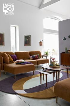 a living room with two couches and a coffee table in front of a large window