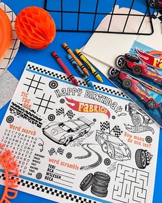 a birthday card with cars on it next to some markers and crayon pens