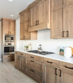 a kitchen with wooden cabinets and white counter tops