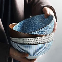 a person holding a blue and white bowl