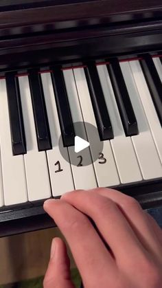 someone is playing the piano with their thumb on it's finger and pressing buttons