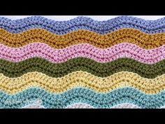 a crocheted blanket is shown with different colors and patterns on the bottom half