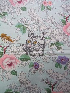 an image of a cat and birds on a floral background