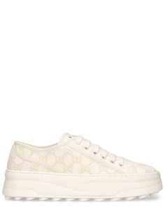 52mm Heel. Off-white canvas with GG embroidered upper. Off-white trim. Front lace-up closure. Logo details. Gucci Tennis 1977 label . All over pattern placement may vary. Rubber platform sole. Includes additional pair of laces All Over Pattern, Ski Accessories, Flat Espadrilles, Swim Accessories, Heeled Loafers, Shearling Jacket, White Trim, Ski Wear, White Canvas