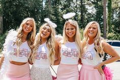 three beautiful young women standing next to each other wearing pink skirts and matching t - shirts