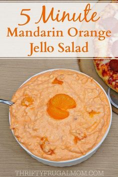 there is an orange jello salad in the bowl and on the table with pizza