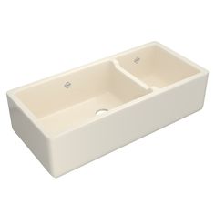 a white double bowl sink with two faucets on the front and one side