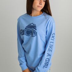 Elevate your winter wardrobe with the Women’s Ski Like A Girl Carolina Blue Long Sleeve T-Shirt. This stylish long sleeve tee features a crisp Carolina blue color and the empowering "Ski Like A Girl" logo, making it a standout choice for women who are passionate about skiing. Crafted from high-quality, soft fabric, this t-shirt provides comfort and warmth for layering on cooler days or for casual wear. Whether you’re hitting the slopes or enjoying a relaxed day out, this long sleeve t-shirt comb Sporty Winter Long Sleeve T-shirt, Sporty Long Sleeve T-shirt For Winter, Sporty Long Sleeve Winter T-shirt, Blue Long Sleeve Trendy T-shirt, Trendy Blue Long Sleeve T-shirt, Blue Screen Print Top For Winter, Blue Screen Print Tops For Winter, Blue Long Sleeve T-shirt, Sporty Long Sleeve Blue T-shirt