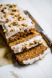 a piece of cake with white frosting and nuts on top