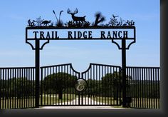 the entrance gate to trail ridge ranch with deer and elk on it's top