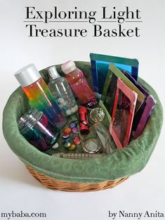 a basket filled with lots of different items on top of a white table next to the words exploring light treasure basket