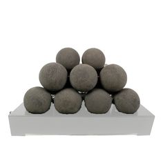 there is a black display case with balls on it and the bottom half has six gray balls in it