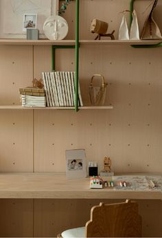 a wooden desk topped with lots of shelves filled with books and other items on top of it