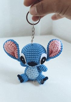 a crocheted keychain with an adorable little blue stitched mouse hanging from it's side