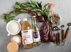 the ingredients to make an apple cider recipe are laid out on a gray surface