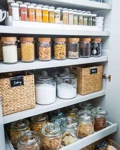 a pantry filled with lots of different types of food and containers on the bottom shelf