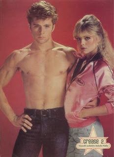 the young man and woman are posing for a magazine cover photo together, with one holding his shirt off