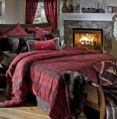 a bed room with a neatly made bed and a fire place