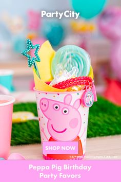 the peppa pig birthday party favors are in pink cups with balloons and streamers