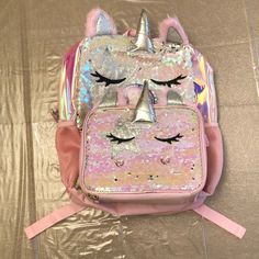 Wonder Nation: Two Piece Set, Backpack And Lunch Bag Cooler. Pink Multi-Color Unicorn Queen. ~ 100% Cordura Material ~ Wipe Clean ~ Dual Zip Around Closure ~ Adjustable Shoulder Straps ~ 17” Laptop Backpack ~ Lunch Bag Cooler Attaches Via Velcro Mini Straps Measurements: ~ Backpack: 12”W X 16”H X 5”D ~ Lunch Bag: 9.25”W X 7.5”H X 3”D Exterior: ~ Brushed Sequins ~ 3d Foam Plush Ears And Horn ~ Glitter Appliqus ~ Heart Shaped Rhinestone Appliqus ~ Foam Mesh Side Pockets Interior: ~ Single Main Com Cute Pink Backpack With Unicorn Print, Pink Unicorn Print Backpack, Pink Unicorn Print School Bags, Pink Unicorn Print Backpack For Back To School, Pink Unicorn Print Standard Backpack, Pink Lunch Bag, Shark Backpack, Sleepover Bag, Sequin Backpack