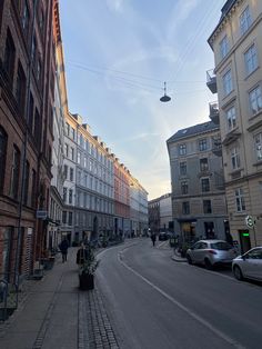 an empty city street lined with tall buildings