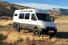 a white van parked in the middle of a field