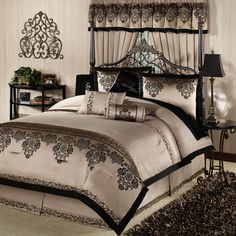 a bed with black and white comforters in a bedroom