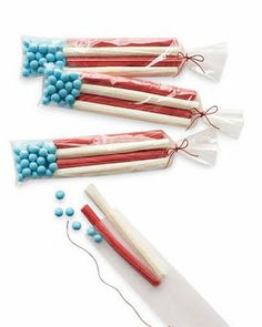 three candy sticks with red, white and blue candies in them