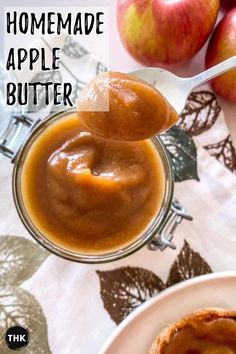 homemade apple butter is being spooned into a jar