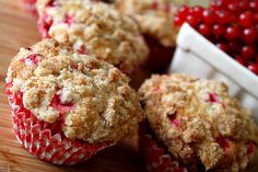 some cranberry muffins on a wooden table