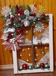 an old window decorated with christmas decorations