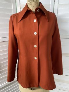 Vintage 70s Disco Long Sleeve Polyester Blouse Womens Size Medium Big pointed collar. Buttons down the front. Long sleeves. Two front pockets. Measurement laying flat Pit to pit 19.5" Length 26.5" Sleeves shoulder to wrist 23" Burnt orange color. Very 70s. Great disco look No flaws to note. Excellent condition. Retro Collared Blouse For Work, Fitted Button-up Outerwear With Placket, Classic Fitted Blouse With Pockets, Retro Solid Color Outerwear For Work, Retro Fall Workwear Tops, Retro Outerwear With Pockets For Office, Brown Spread Collar Blouse For Fall, Single-breasted Blouse With Lapel Collar For Fall, Fall Blouse With Single Breasted Lapel Collar